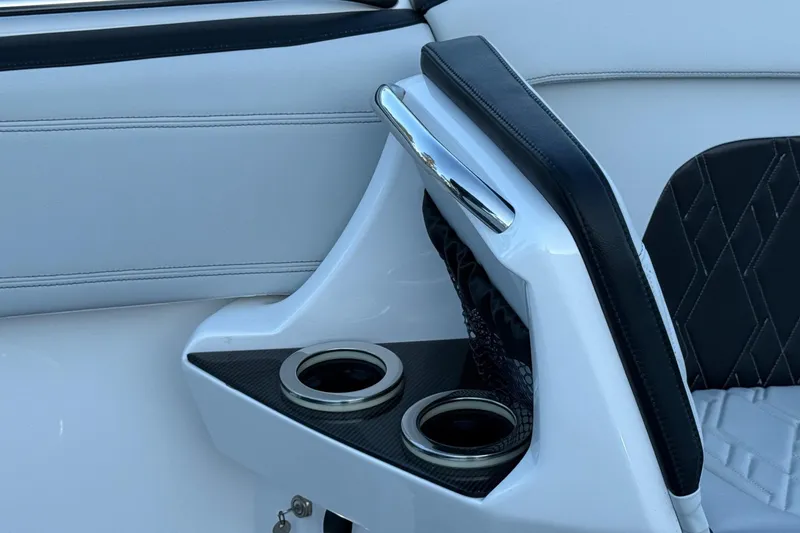 Slide: The Image of 2024 Nor-Tech 400 Supersport interior detail with cup holders and sleek upholstery design. - 25