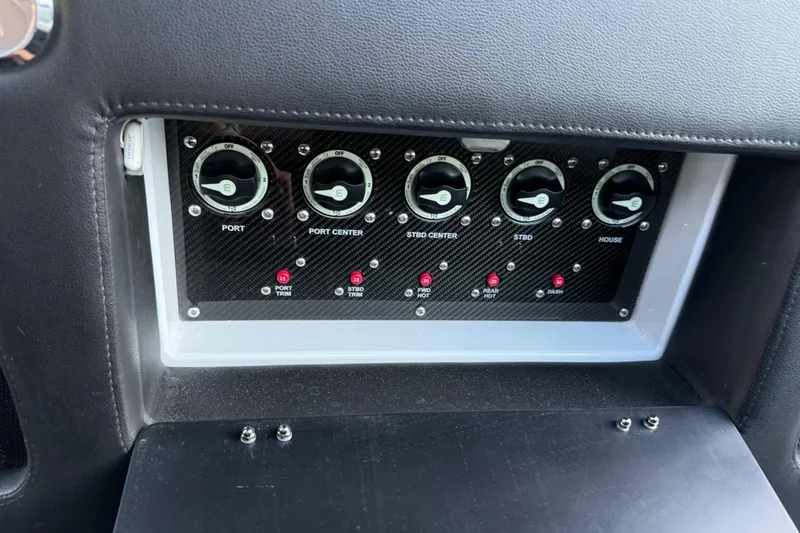 Slide: The Image of Control panel of 2024 Nor-Tech 400 Supersport boat with labeled switches and dials. - 28