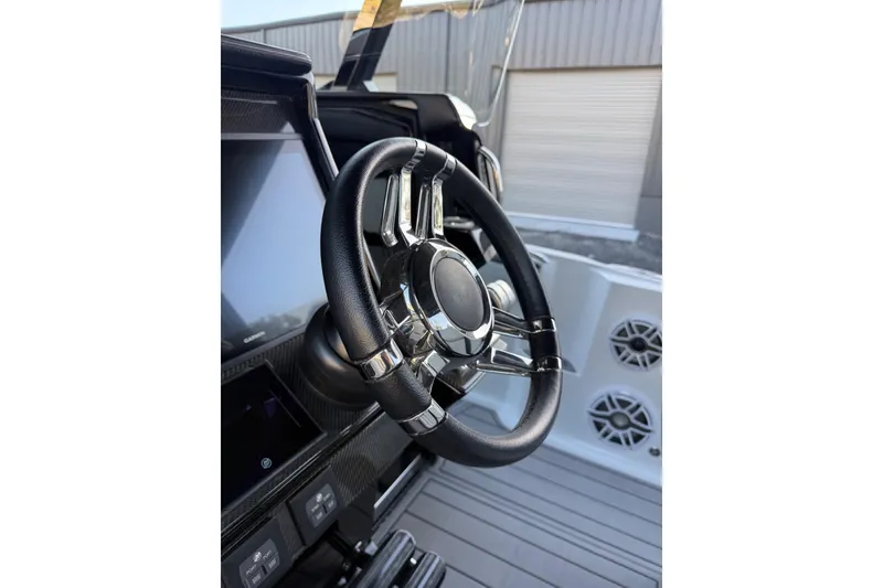 Slide: The Image of Steering wheel of 2024 Nor-Tech 400 Supersport boat, featuring modern design and controls. - 32