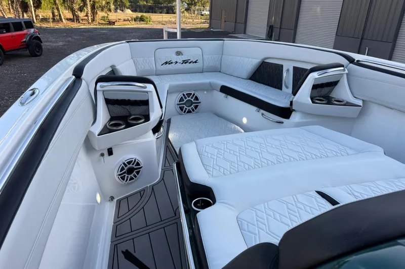 Slide: The Image of 2024 Nor-Tech 400 Supersport boat interior with luxurious white seating and modern design. - 33