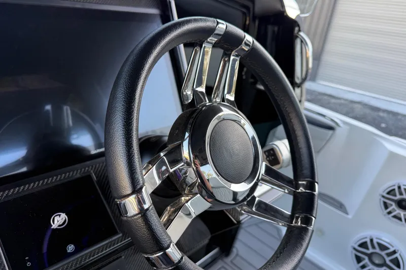 Slide: The Image of Steering wheel of 2024 Nor-Tech 400 Supersport boat, featuring sleek design and modern controls. - 42