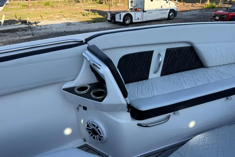 Slide: The Image of 2024 Nor-Tech 400 Supersport interior with white seating, cup holders, and speaker. - 43