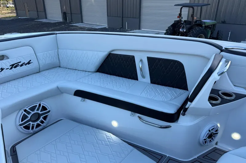 Slide: The Image of 2024 Nor-Tech 400 Supersport interior with white quilted seating and built-in speakers. - 46