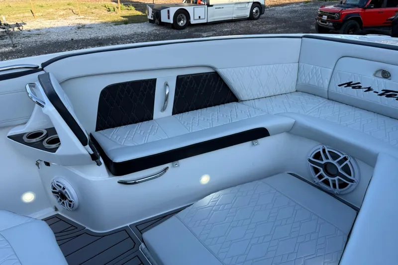 Slide: The Image of Luxurious interior of 2024 Nor-Tech 400 Supersport boat with elegant seating and speakers. - 48