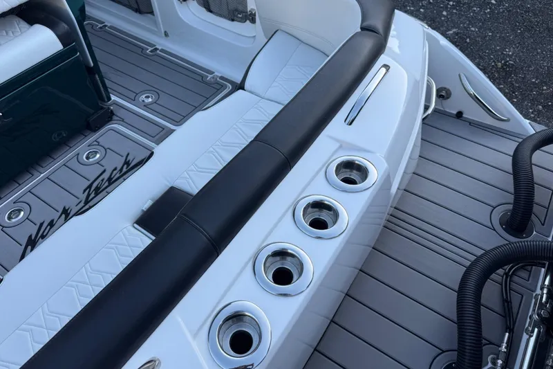 Slide: The Image of 2024 Nor-Tech 400 Supersport boat deck with cup holders and sleek seating design. - 50