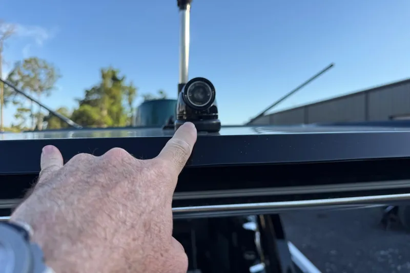 Slide: The Image of Close-up of a person pointing at a camera on a 2024 Nor-Tech 400 Supersport boat. - 51