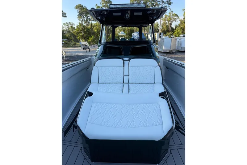 Slide: The Image of 2024 Nor-Tech 400 Supersport boat with luxurious white seating and sleek design. - 52