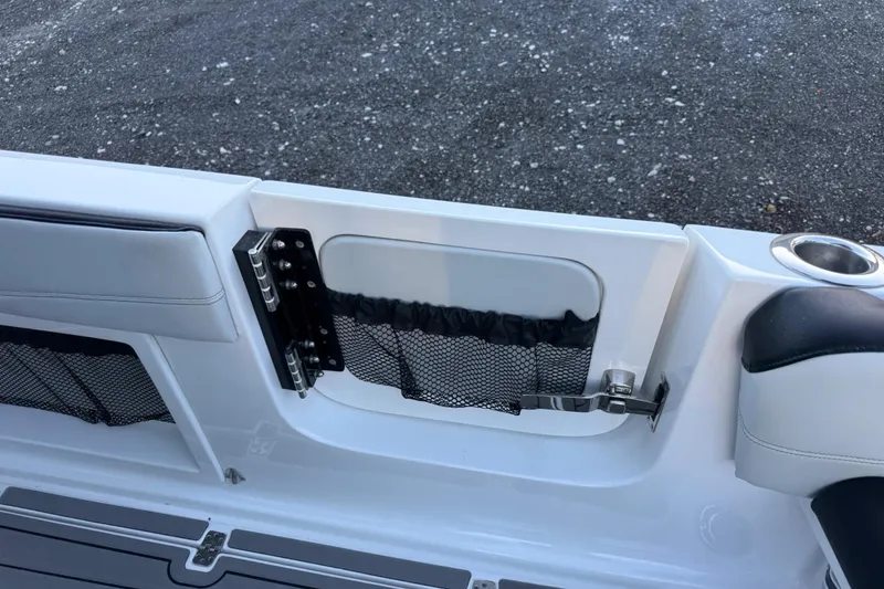 Slide: The Image of 2024 Nor-Tech 400 Supersport boat interior with storage compartment and cup holder. - 54