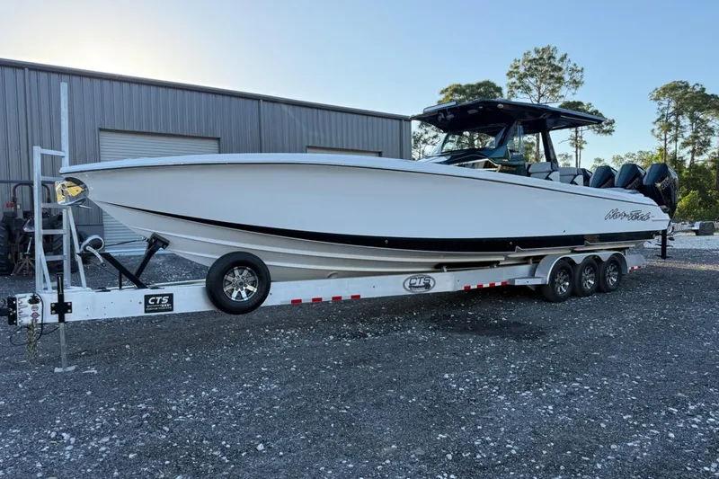 Slide: The Image of 2024 Nor-Tech 400 Supersport boat on trailer, parked outdoors near a warehouse. - 55