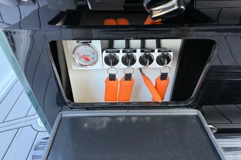 Slide: The Image of Control panel of 2024 Nor-Tech 400 Supersport boat with switches and fuel gauge. - 60
