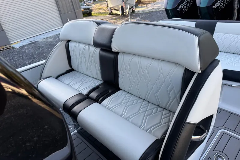 Slide: The Image of Luxurious seating in the 2024 Nor-Tech 400 Supersport boat, featuring elegant black and white upholstery. - 65