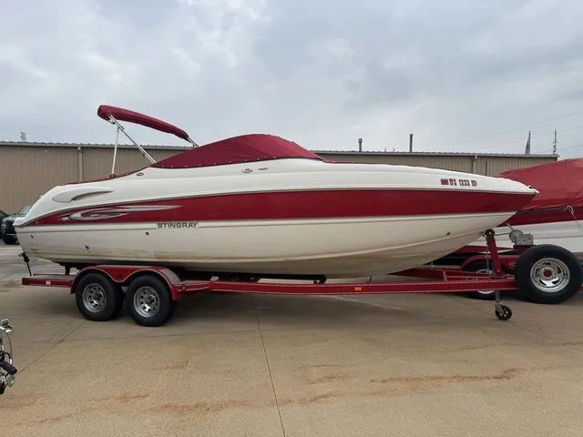 The Image of 2007 Stingray 250 LR boat on trailer, red and white. - 1