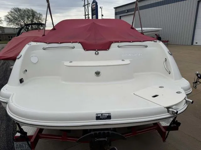 Slide: The Image of Rear view of a 2007 Stingray 250 LR boat with red cover. - 4