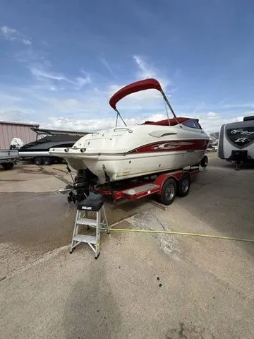 Slide: The Image of 2007 Stingray 250 LR boat on trailer outdoors. - 5