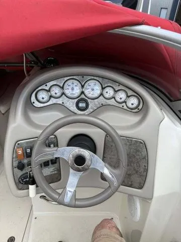 Slide: The Image of Dashboard of a 2007 Stingray 250 LR boat with red canopy. - 8