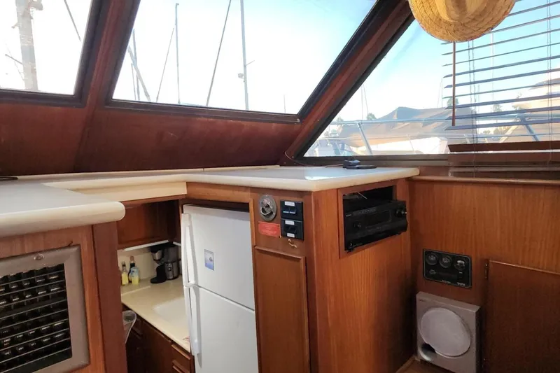 Slide: The Image of Interior of 1978 Hatteras 45 Express Sportfish with wood paneling and kitchen amenities. - 9