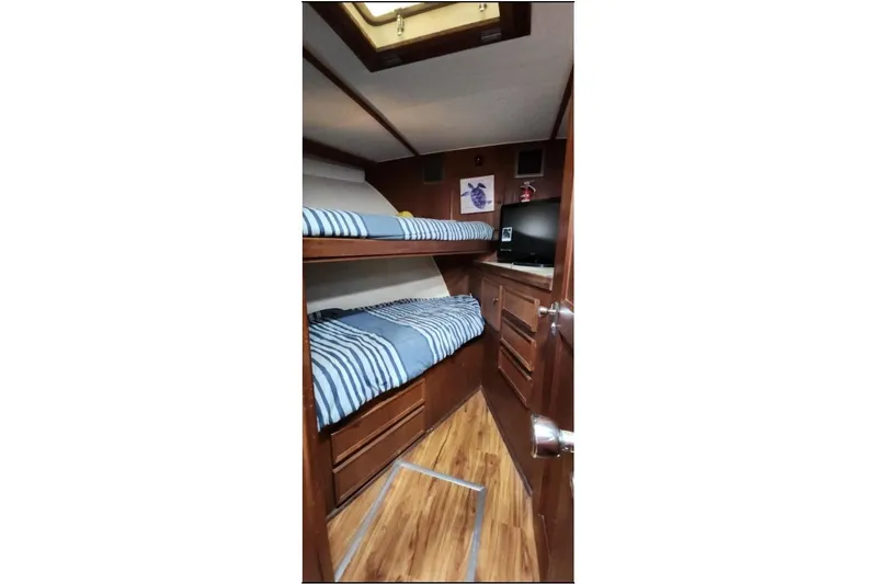 Slide: The Image of Interior cabin of 1978 Hatteras 45 Express Sportfish with bunk beds and wood finish. - 17