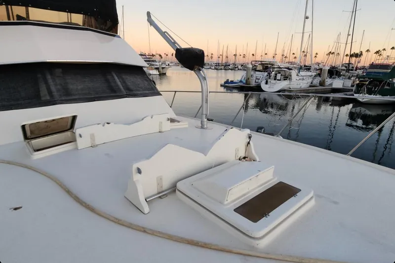 Slide: The Image of 1978 Hatteras 45 Express Sportfish yacht docked at marina during sunset. - 18