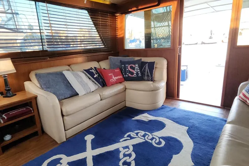 Slide: The Image of Interior of 1978 Hatteras 45 Express Sportfish with nautical-themed decor and cozy seating. - 7