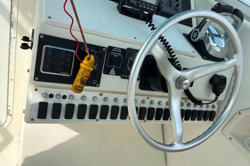 Slide: The Image of Control panel of a 1998 Hydrocat 300X boat with steering wheel and switches. - 10