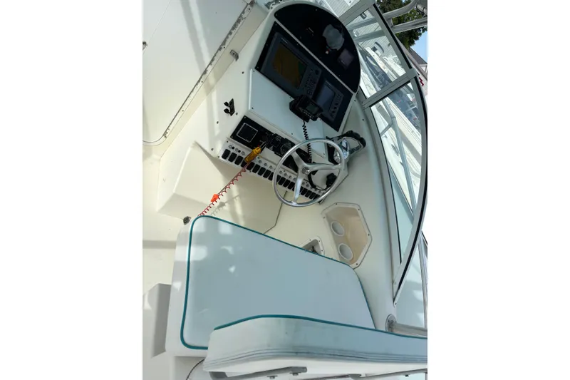 Slide: The Image of 1998 Hydrocat 300X boat cockpit with steering wheel and control panel. - 11
