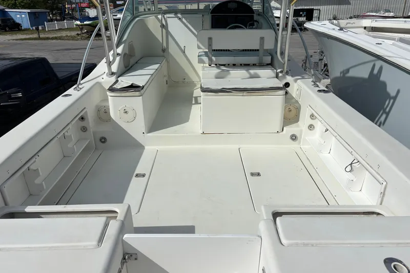 Slide: The Image of 1998 Hydrocat 300X boat interior with spacious deck and seating area. - 12
