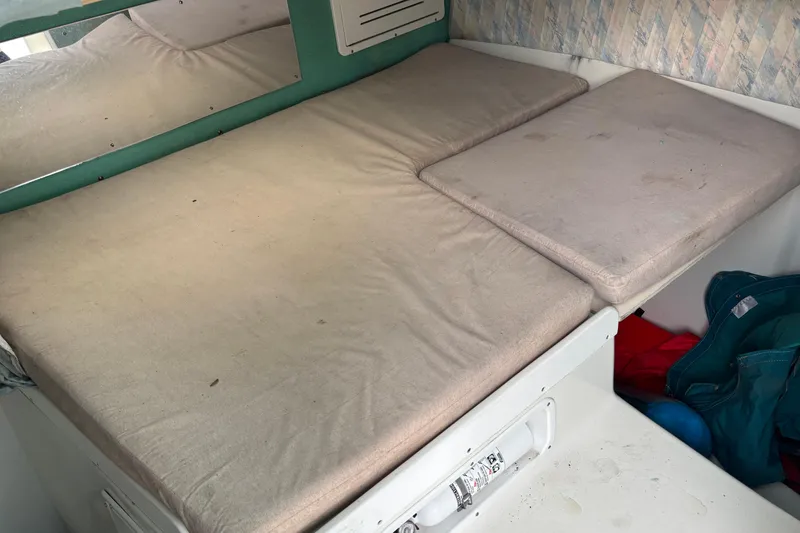Slide: The Image of Interior cabin of a 1998 Hydrocat 300X boat with cushioned seating. - 20