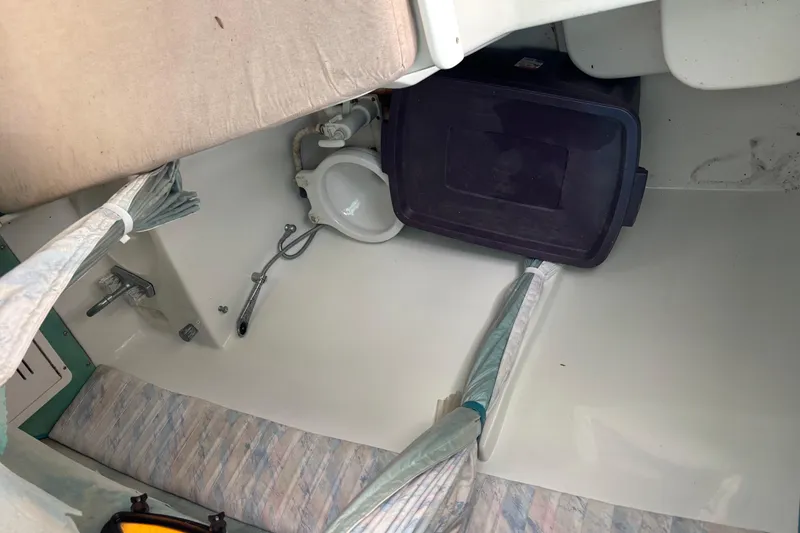 Slide: The Image of Interior of a 1998 Hydrocat 300X boat showing storage and seating area. - 21