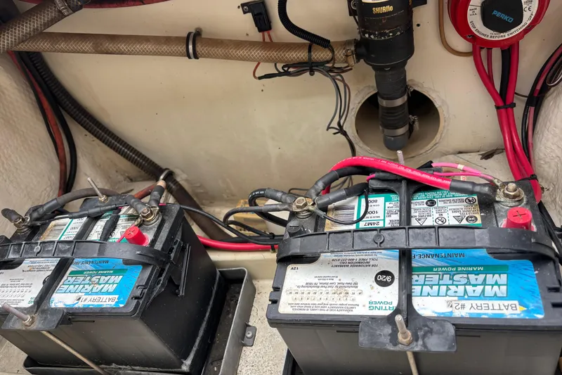 Slide: The Image of Marine batteries in a 1998 Hydrocat 300X boat, connected with cables and wiring. - 22