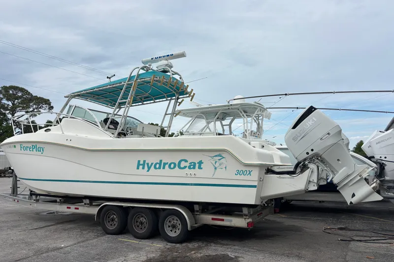 Slide: The Image of 1998 Hydrocat 300X boat on trailer with Suzuki outboard motor. - 3