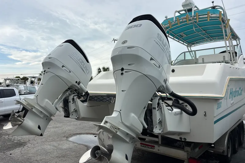 Slide: The Image of 1998 Hydrocat 300X boat with dual Suzuki outboard motors on a trailer. - 6