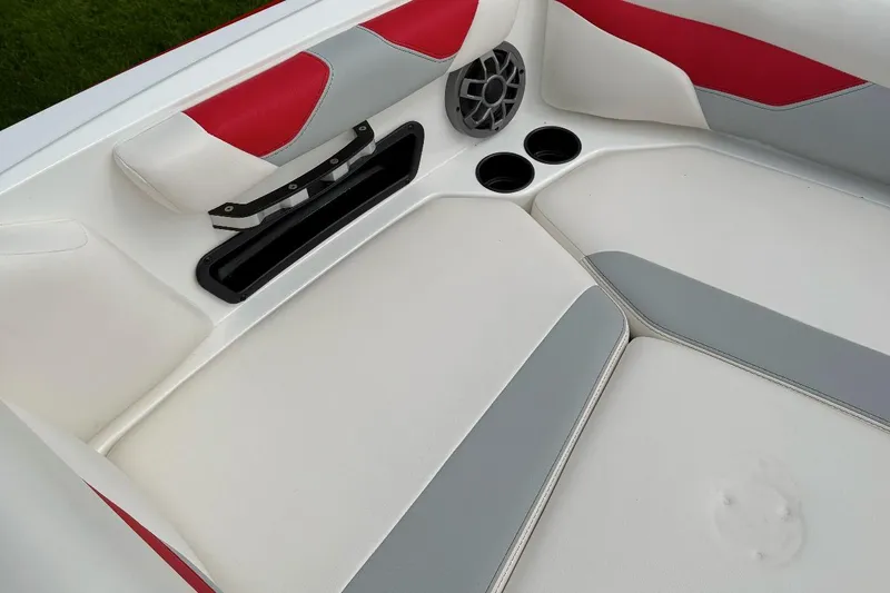 Slide: The Image of Interior of 2020 Axis A20 boat with red, white, and gray seating, cup holders, and speaker. - 10