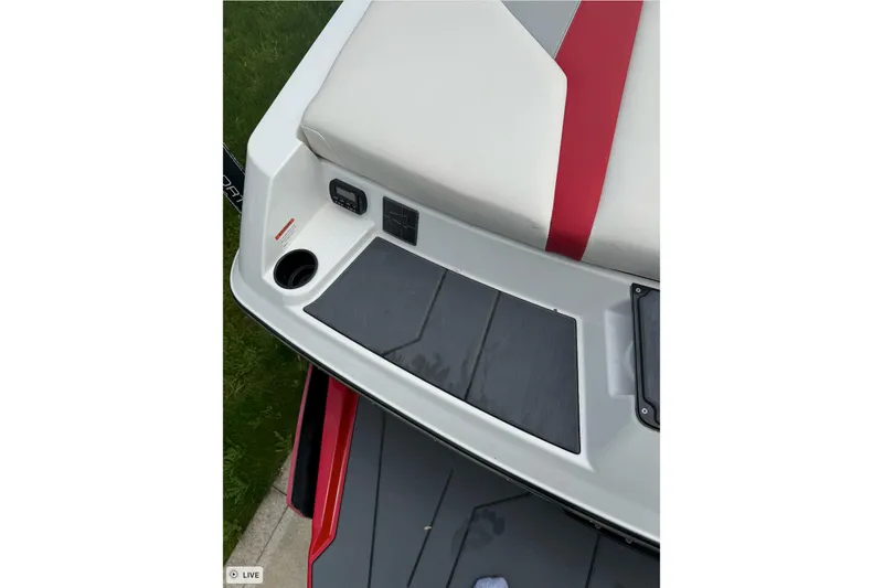 Slide: The Image of 2020 Axis A20 boat interior with red and white seating, cup holder, and control panel. - 11