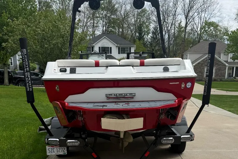 Slide: The Image of 2020 Axis A20 boat on trailer in suburban driveway. - 14