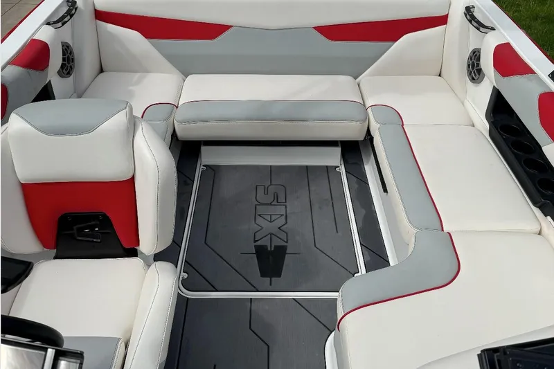 Slide: The Image of 2020 Axis A20 boat interior with red and gray seating, featuring cup holders and speakers. - 3