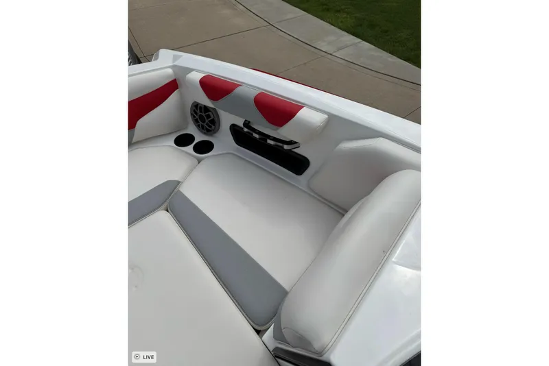 Slide: The Image of 2020 Axis A20 boat interior with white and red seating, cup holders, and speaker. - 9
