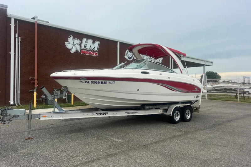 The Image of 2006 Chaparral 256 SSi boat on trailer outside HM Boats building. - 0