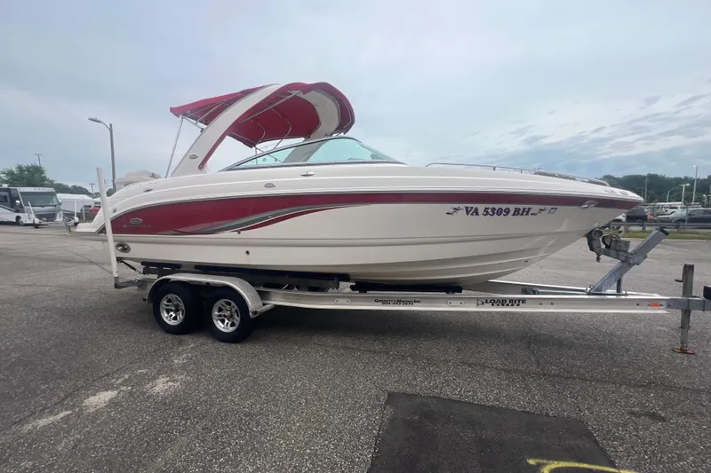 Slide: The Image of 2006 Chaparral 256 SSi boat on trailer, featuring red and white design. - 11