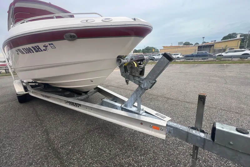 Slide: The Image of 2006 Chaparral 256 SSi boat on trailer in parking lot, overcast sky. - 14