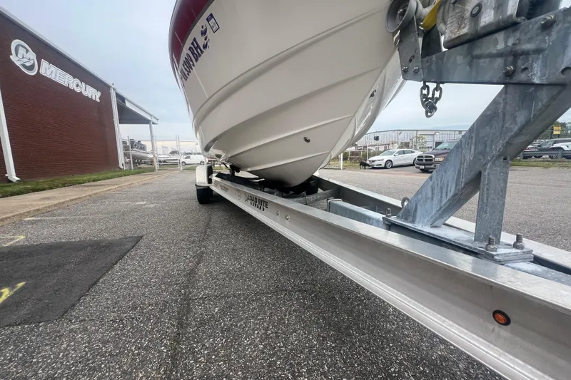 Slide: The Image of 2006 Chaparral 256 SSi boat on trailer near Mercury building, parked on asphalt. - 15