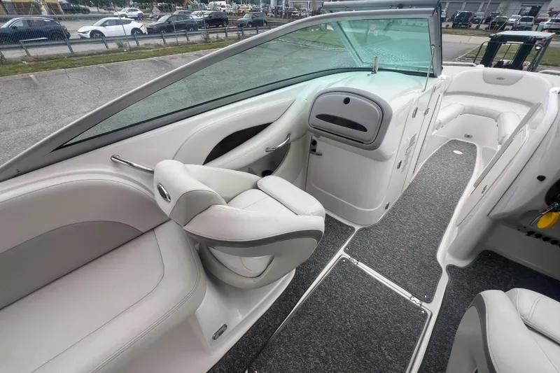 Slide: The Image of 2006 Chaparral 256 SSi boat interior with white seating and gray carpet. - 19