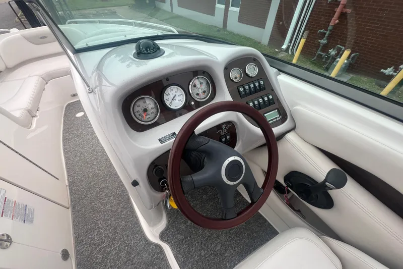 Slide: The Image of 2006 Chaparral 256 SSi boat dashboard with gauges and steering wheel. - 21