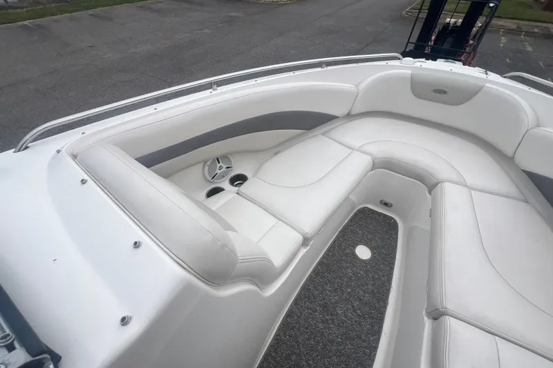 Slide: The Image of 2006 Chaparral 256 SSi boat interior with white cushioned seating and gray accents. - 23