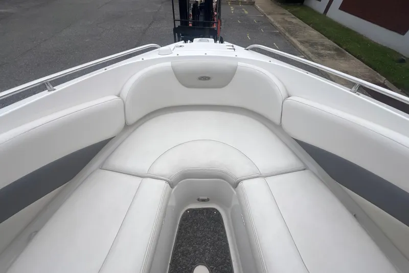 Slide: The Image of 2006 Chaparral 256 SSi boat interior with white cushioned seating and gray accents. - 25