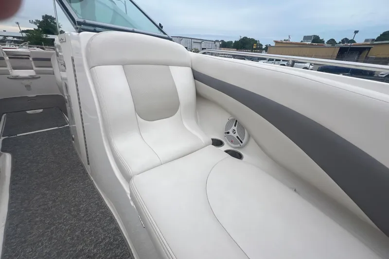Slide: The Image of 2006 Chaparral 256 SSi boat interior with white seating and speaker detail. - 27