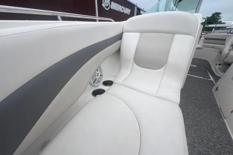 Slide: The Image of 2006 Chaparral 256 SSi boat interior with white seating and cup holders. - 28
