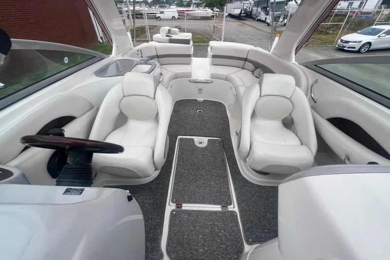 Slide: The Image of 2006 Chaparral 256 SSi boat interior with white seating and gray carpet. - 29