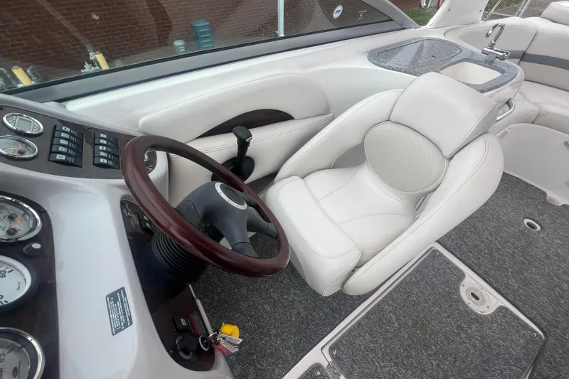 Slide: The Image of Interior of 2006 Chaparral 256 SSi boat with steering wheel and white captain's chair. - 30
