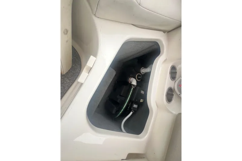 Slide: The Image of 2006 Chaparral 256 SSi boat interior compartment with visible wiring and plumbing components. - 31