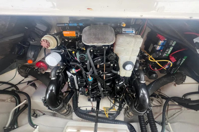 Slide: The Image of Engine compartment of a 2006 Chaparral 256 SSi boat, showcasing various components and wiring. - 35